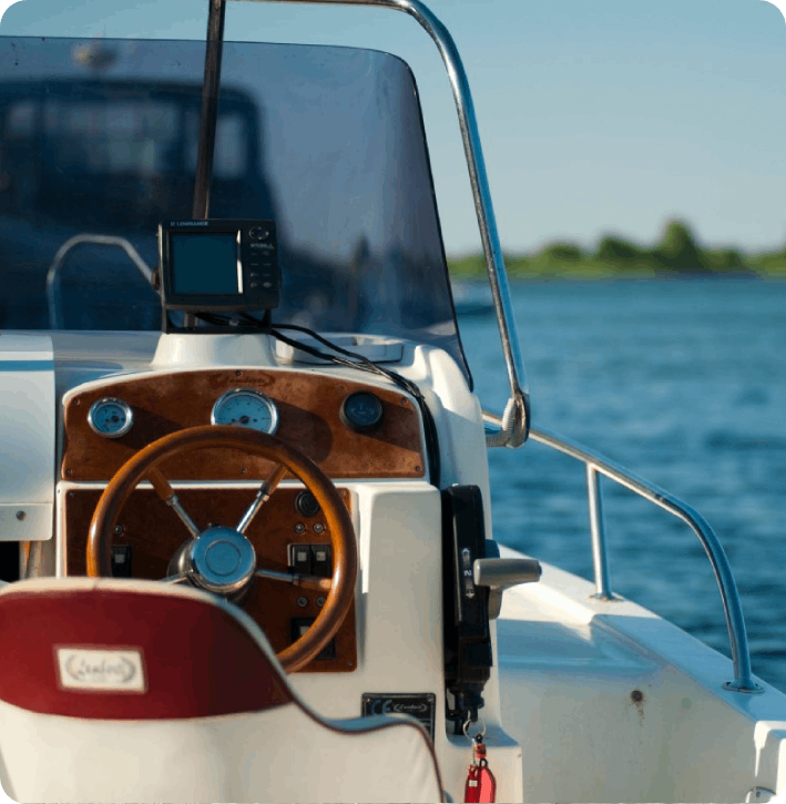 A boat with the steering wheel and controls on it.