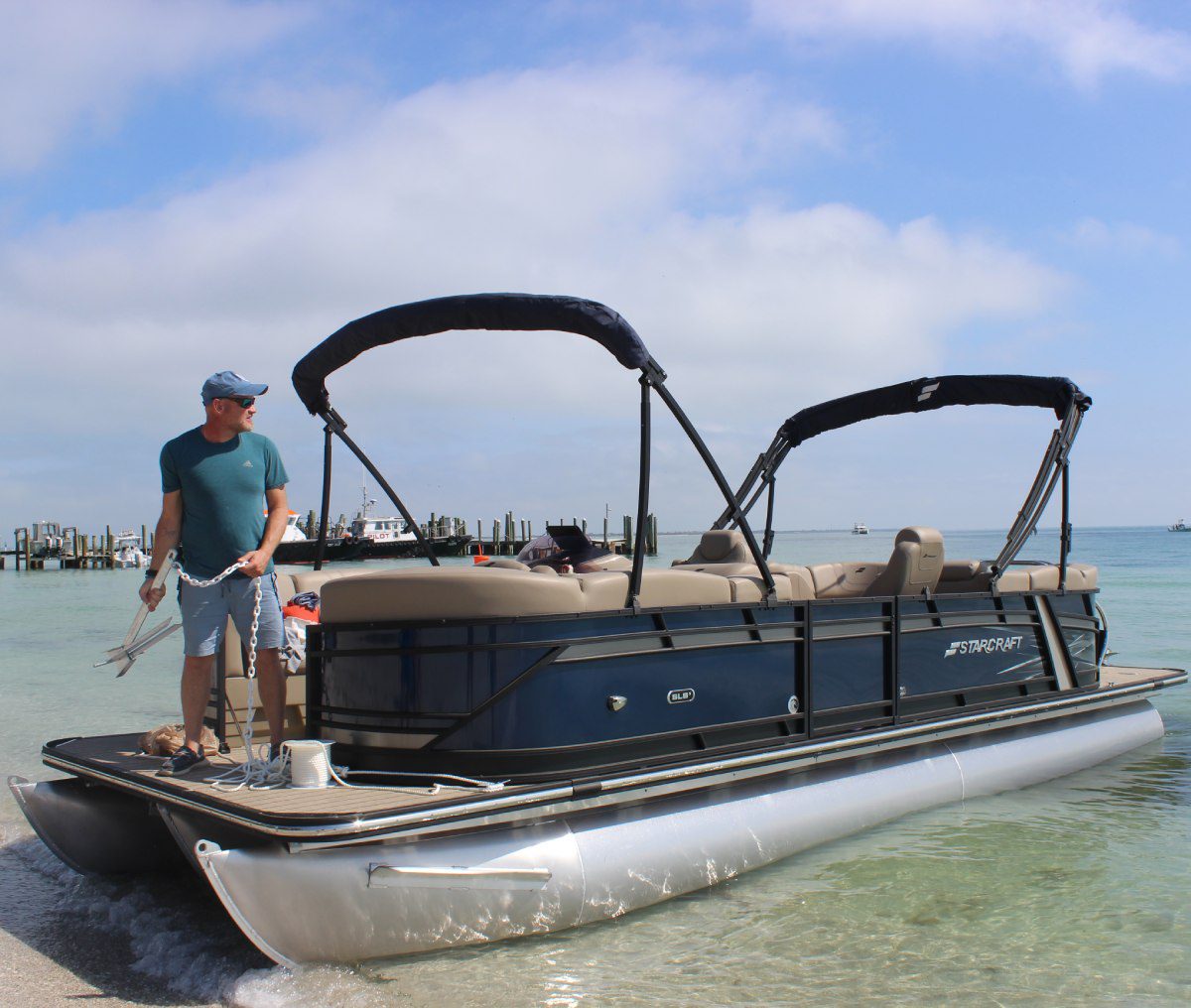 A man standing on the back of a boat.