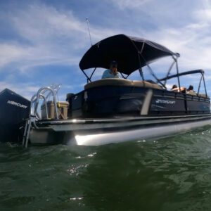 A boat with people in it is on the water.