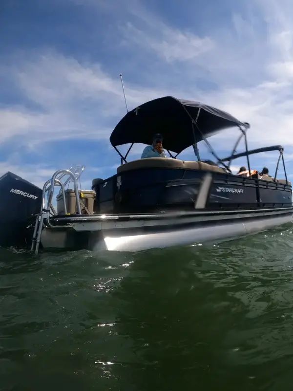 A boat with people in it is on the water.