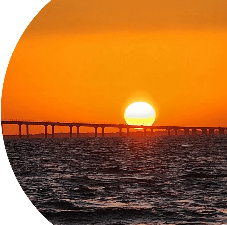 A sunset over the ocean with an orange sky.