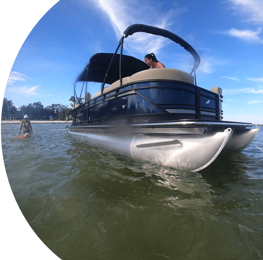 A boat with a man in the water.